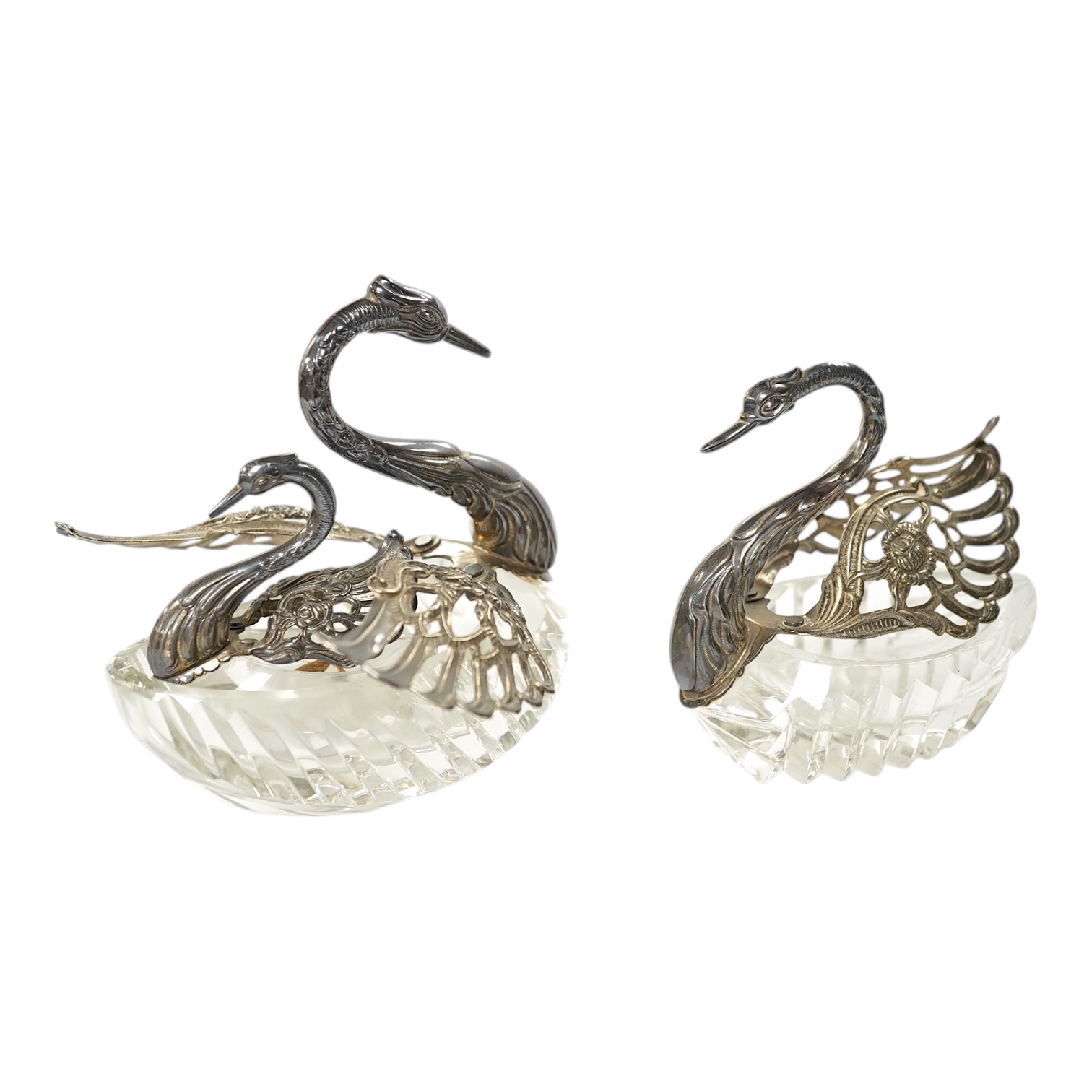 A graduated set of three silver mounted glass swan condiments, London, 1978, largest height 12.9cm. Condition - fair